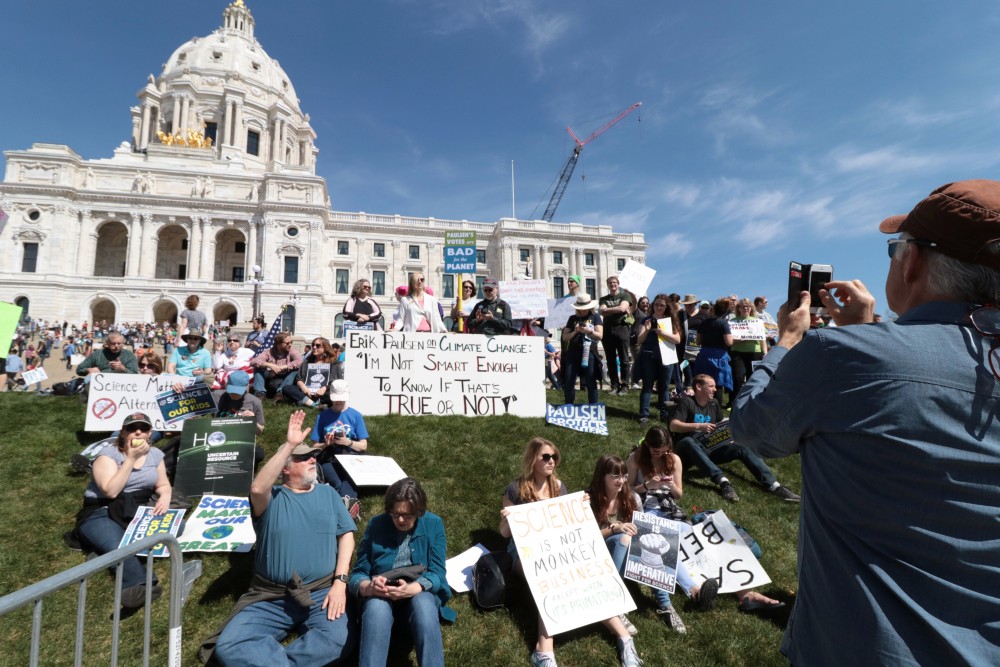 David Son takes a photo of other protesters on Saturday, April 22, 2017 in St. Paul. Thousands marched across the nation to promote funding for scientific research.