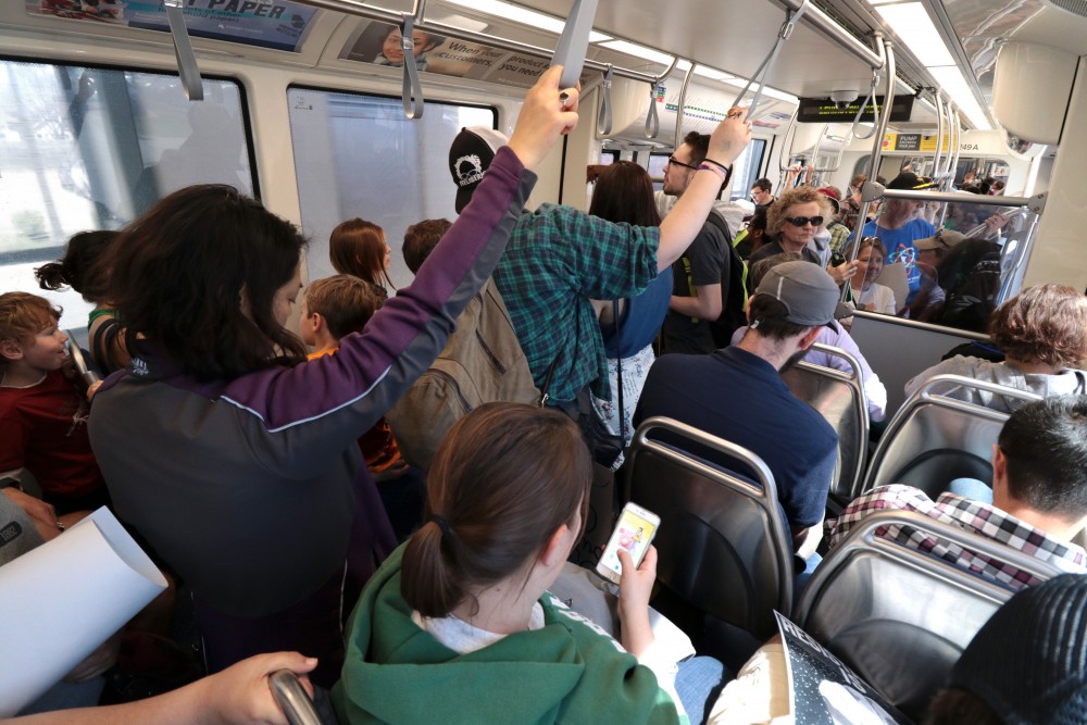 Riders pack a Green Line light rail train on Saturday, April 22, 2017.