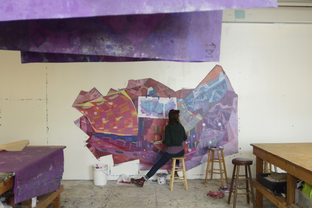 Greta McClain, lead artist of GoodSpace Murals, paints a new project for The John & Denise Graves Foundation on Tuesday, April 25, 2017 in Minneapolis. The muralist group works mostly with schools and non-profit organizations to bring art into the community, including the Universitys HECUA program.