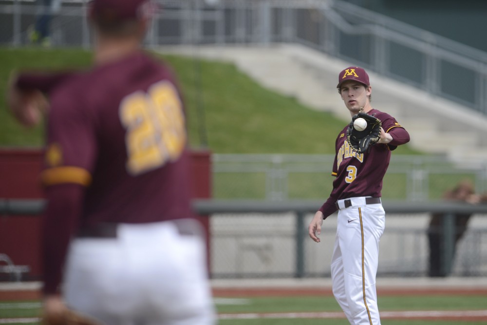 Junior Toby Hanson throws the ball back to pitcher Brett Schulze during the Gophers game against Illinois on Saturday, April 29, 2017 at Siebert Field. 
