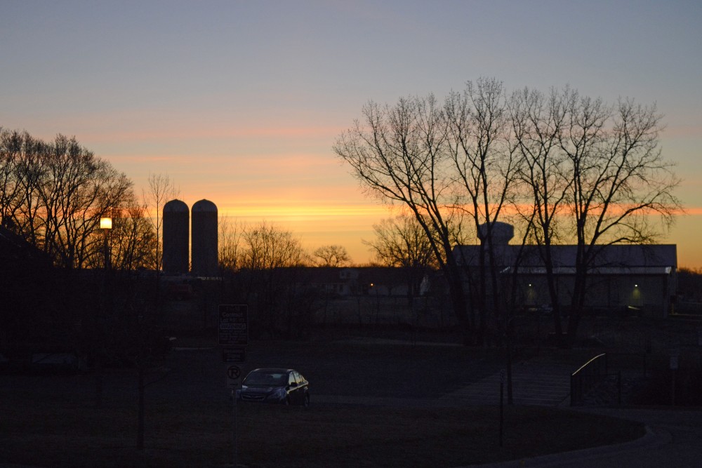 The sun begins to rise over St. Paul campus. 