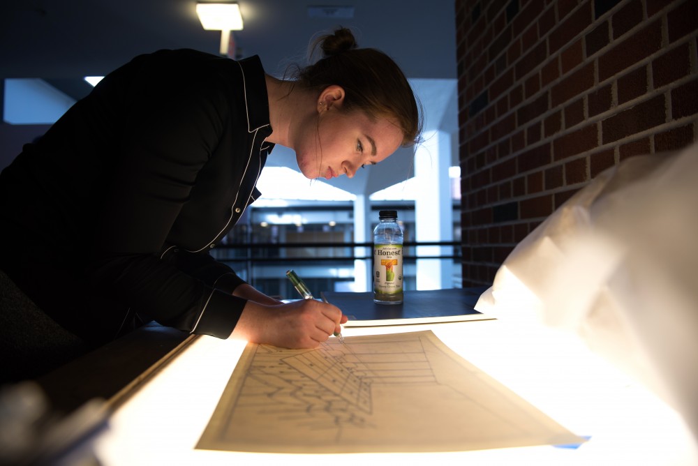Rosemarie Gregoire works on her drawing for a watercolor rendering assignment for an interior design class.