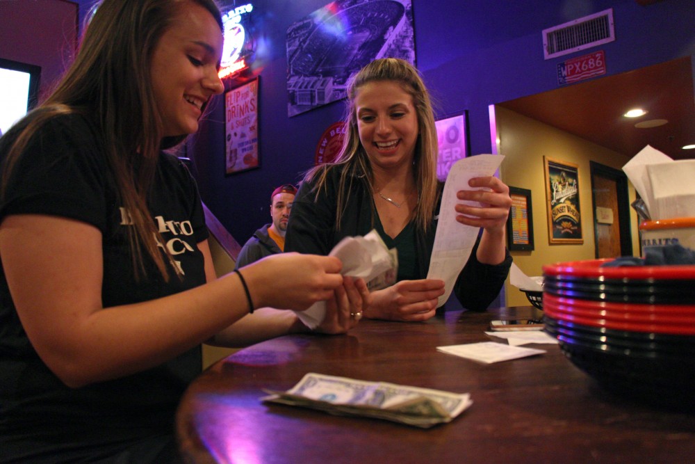 Interior design sophomore Claire Brendel and biology senior Nadia Handler count their tips after getting off work at Burrito Loco.