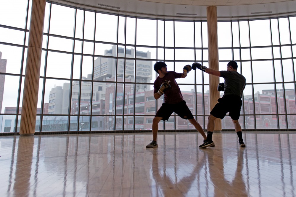 Jason Lin, left, and Bilal Abdelqader box at the University Recreation and Wellness center.