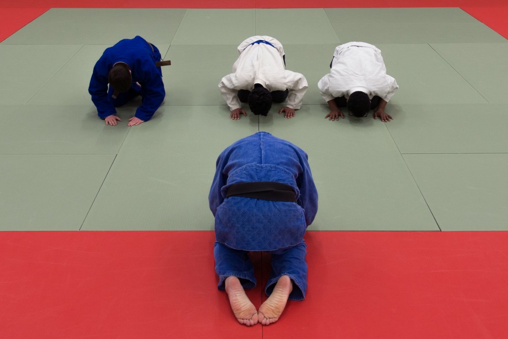 Michael Nardini bows in the judo club before starting practice. 