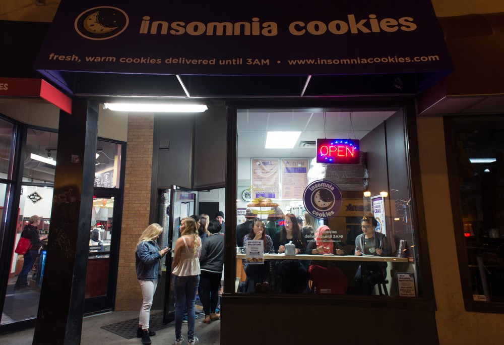 Students line up for fresh cookies at Insomnia Cookies in Dinkytown. 