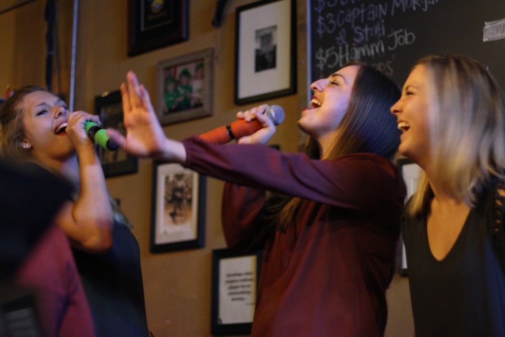 Maddie Nyhus, Jen Anderson and Rylee Reiche sing Def Leppards Pour Some Sugar on Me on karaoke at Blarney Pub & Grill.