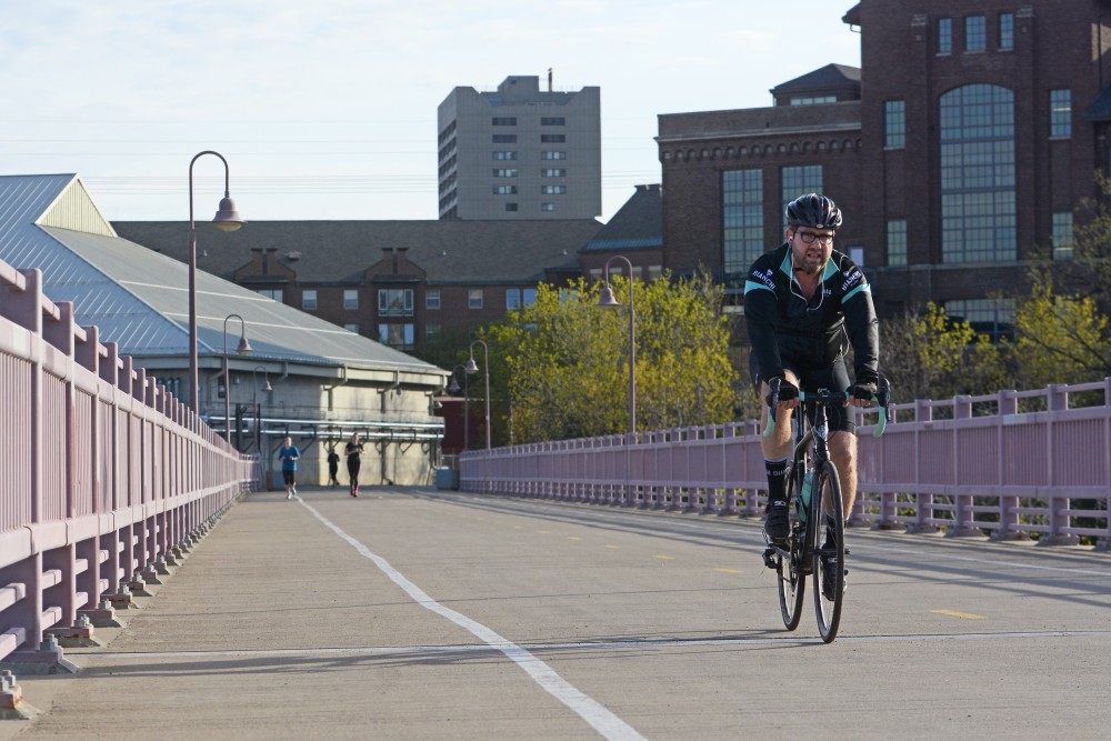 A cyclist crosses the Mississippi River on the Dinkytown Greenway on Sunday, April 23, 2017. 