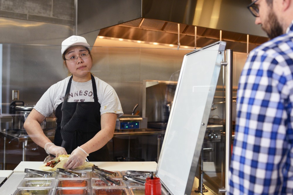 Burrigato co-owner Korra Ektanitphong prepares an asian burrito for U.S. Bank employee Alex Beaulieu at the new Dinkytown restaurant on May 3, 2017. 