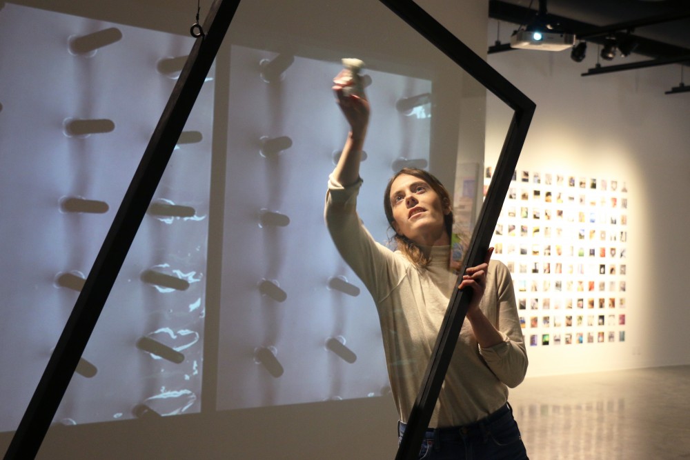 Torey Erin works on her project, Ad Infinitum, for the senior Bachelor of Fine Arts show at the Katherine E. Nash Gallery on May 2, 2017. The installation combines sculpture and video, and will include a printed booklet when the show opens on Friday. 