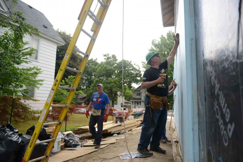 A Minneapolis grant from the U.S. Dept. of Energy is letting the city build MonoPath housing for energy efficient and affordable houses in low income neighborhoods. The energy efficient building technique started at the University of Minnesota in the early 2000s and is now being put back to use after its development was delayed by the 2008 recession. Volunteers are seen working on a Northeast Minneapolis house on Monday, June 19, 2017. 