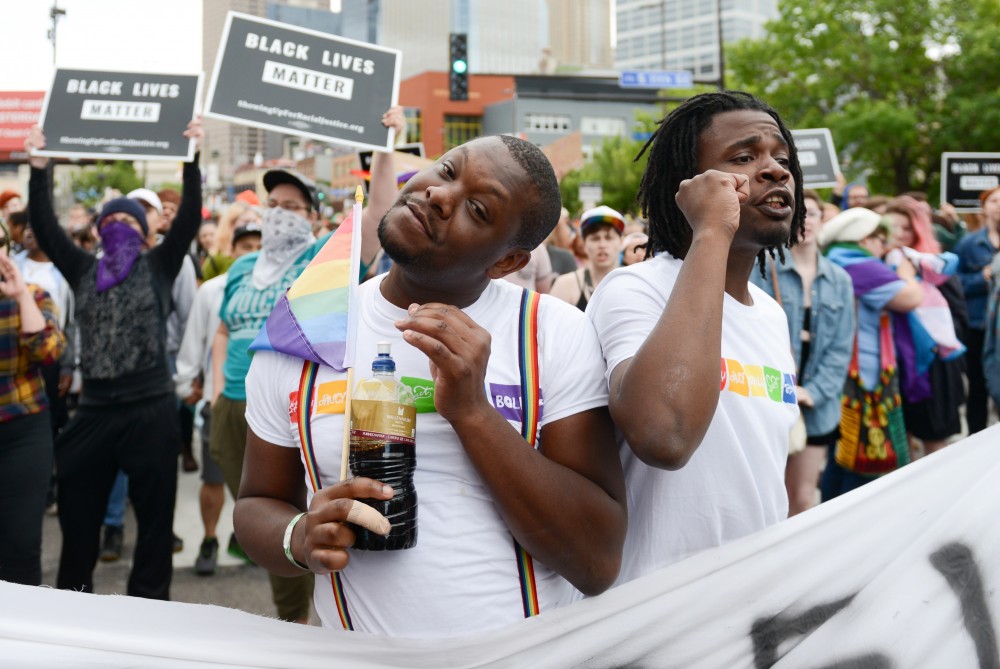 Kevin Gaston left, and Aaron Kirk chant with Black Lives Matter protesters at the start of the annual pride parade.