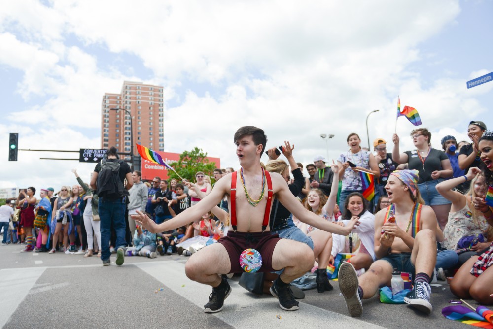 Spectators interact with the floats passing during the pride parade. 
