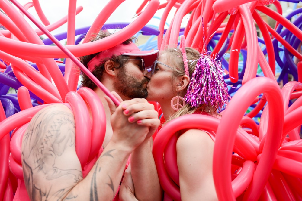 Don and Nicole Townsend kiss under balloons in the pride parade.