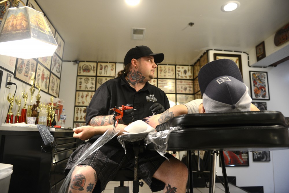Third generation traditional tattooer Daniel Peace works on Drew Allen at Dinkytown Tattoo on June 3, 2017.