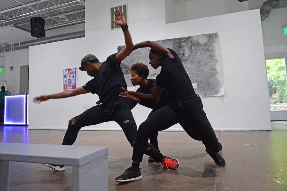 Alanna Morris-Van Tassel, Darwin Black and Taylor Collier perform at The Shop, an art exhibition focused on black barbershop culture, on July 1.