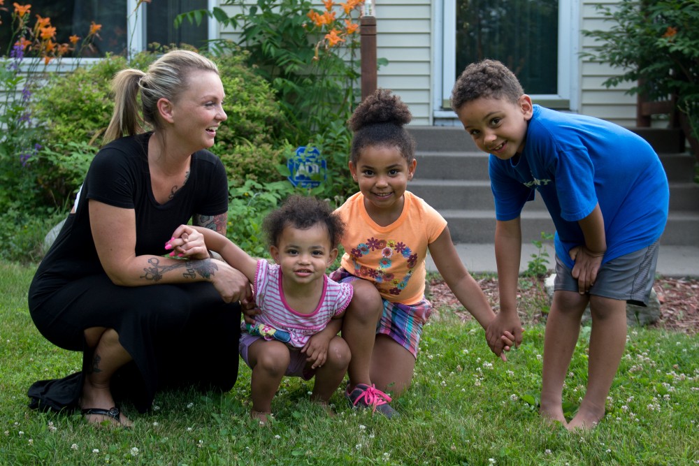 Brittany Seaver poses for portraits with her children Serenidee, Jazzlynn and William Watson outside their home in Plymouth, Minnesota on Monday. Brittany is now involved with the Minnesota Prison Doula Project, giving support and advice to pregnant inmates and new moms who are incarcerated.