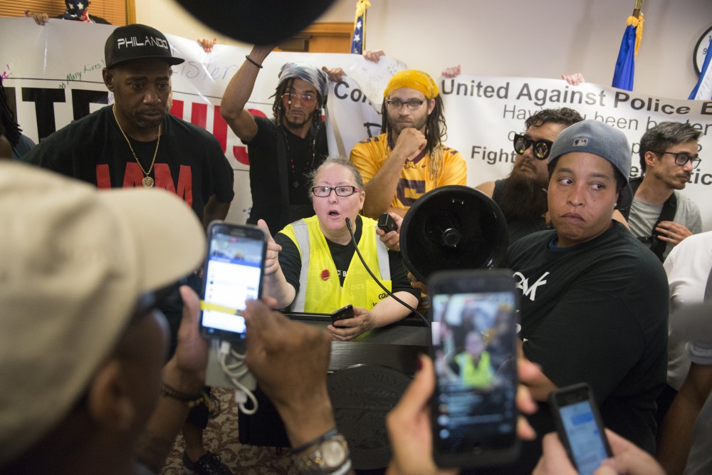 Protesters speak after news breaks about Police Chief Janee´ Harteaus resignation on Friday at Minneapolis City Hall.