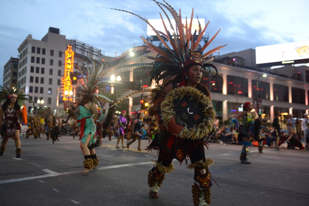 Dancers of Kalpulli Ketzal Coatlicue dance in the 17th annual CenterPoint Energy Torchlight Parade along Hennepin Avenue on Wednesday.