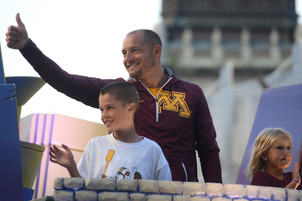 Head football coach P.J. Fleck leads the 17th annual CenterPoint Energy Torchlight Parade as Grand Marshal along Hennepin Avenue on Wednesday.
