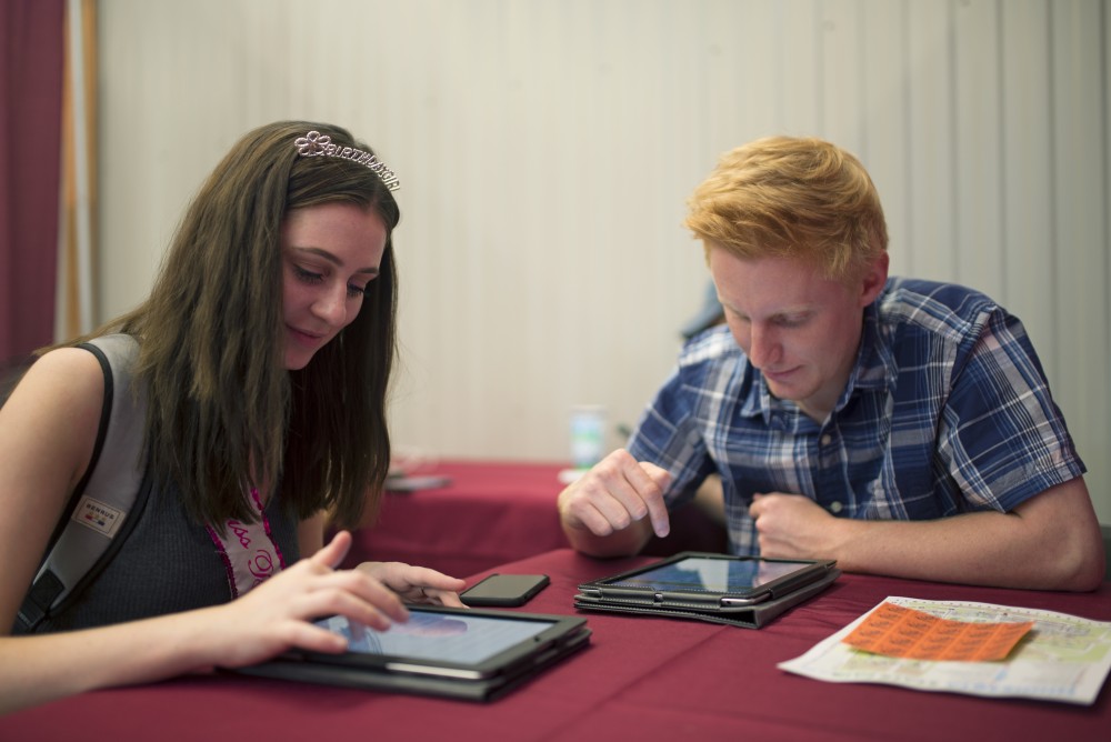 Kathyn Zabloski and Trevor Driscoll participate in University research in the Driven to Discover building at the Minnesota State Fair on Aug. 31.