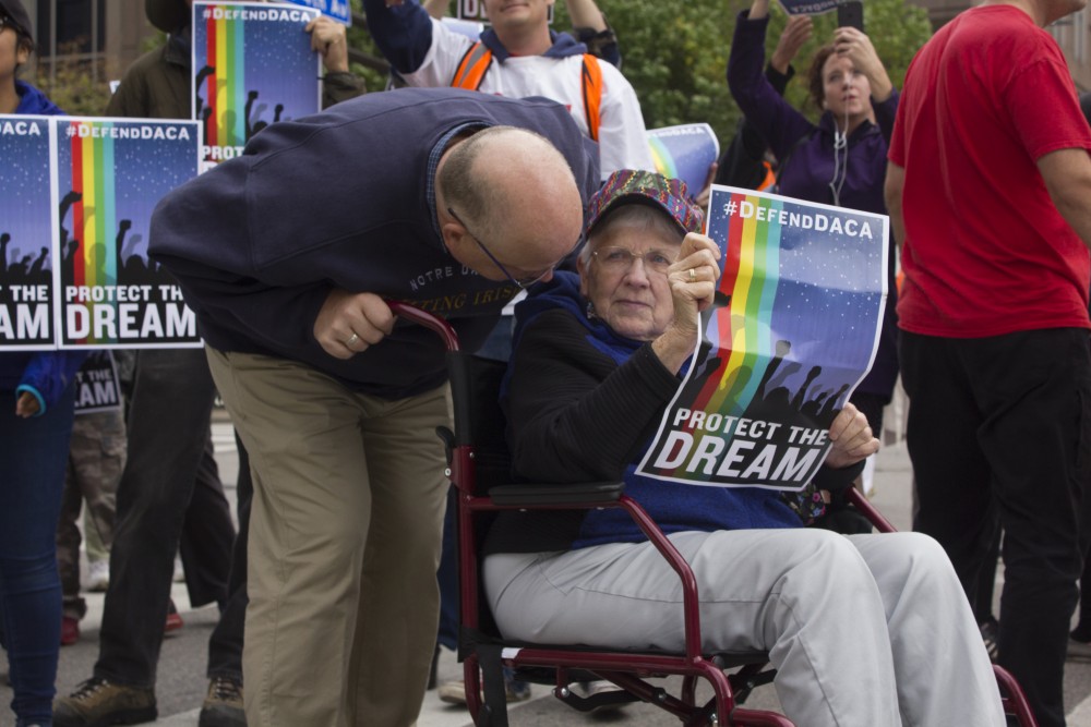 Protester Peter Summers and his 85-year-old mother, Sally, cheer on protestors near the end of the march on Sept. 5. This issue comes down to justice and just decency. The removal of DACA is a huge threat to our democracy, Summers said.  