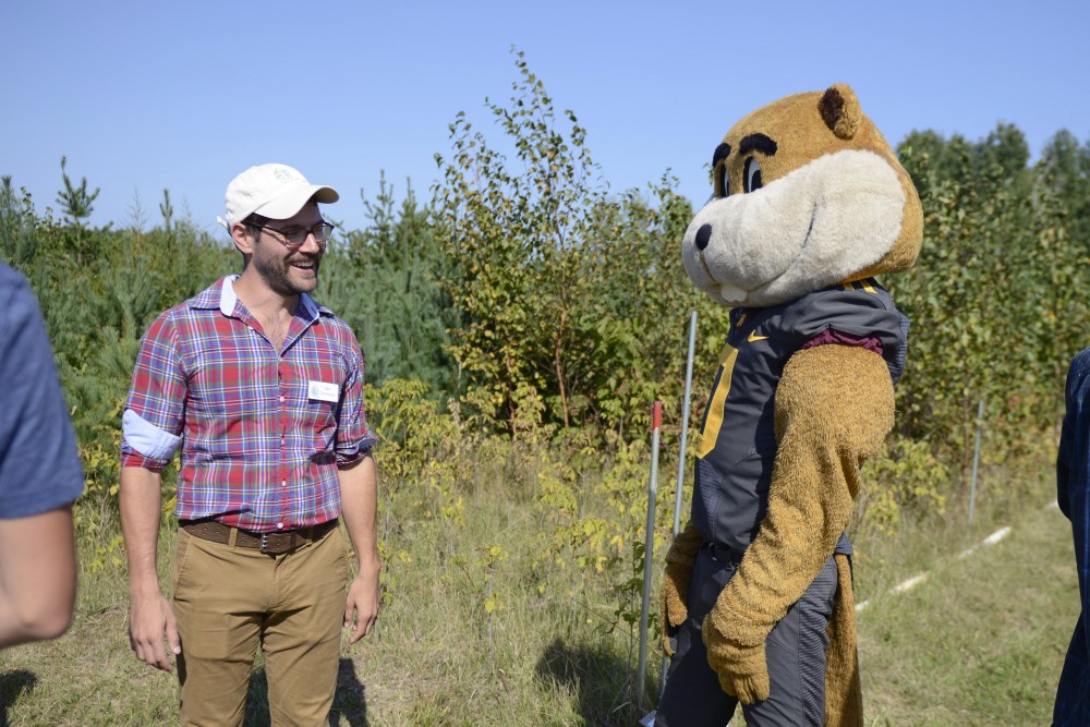 UMN Grad Student Jake Grossman warns Goldy Gopher to stay on the trail at the Cedar Creek Ecosystem Science Reserve in East Bethel on Saturday, Sept. 9. The center recently turned 75 years old and teaches scientists the current understanding of biodiversity and its importance.