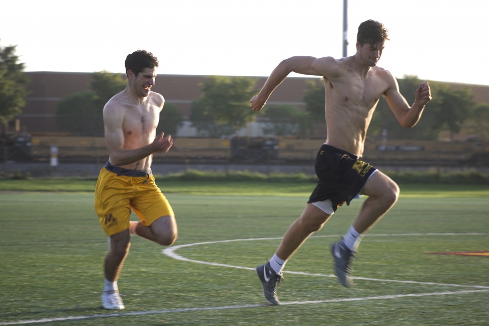 Ely Harel and Clay Diedrich, club lacrosse players at the University of Minnesota, run sprints after practice ended on Thursday, Sept. 14. The team is hoping to become an accredited University sport. 