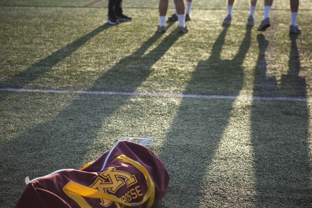 University of Minnesota club lacrosse players talk after their 6 a.m. practice on Thursday, Sept. 14. The team is hoping to become an accredited University sport. 