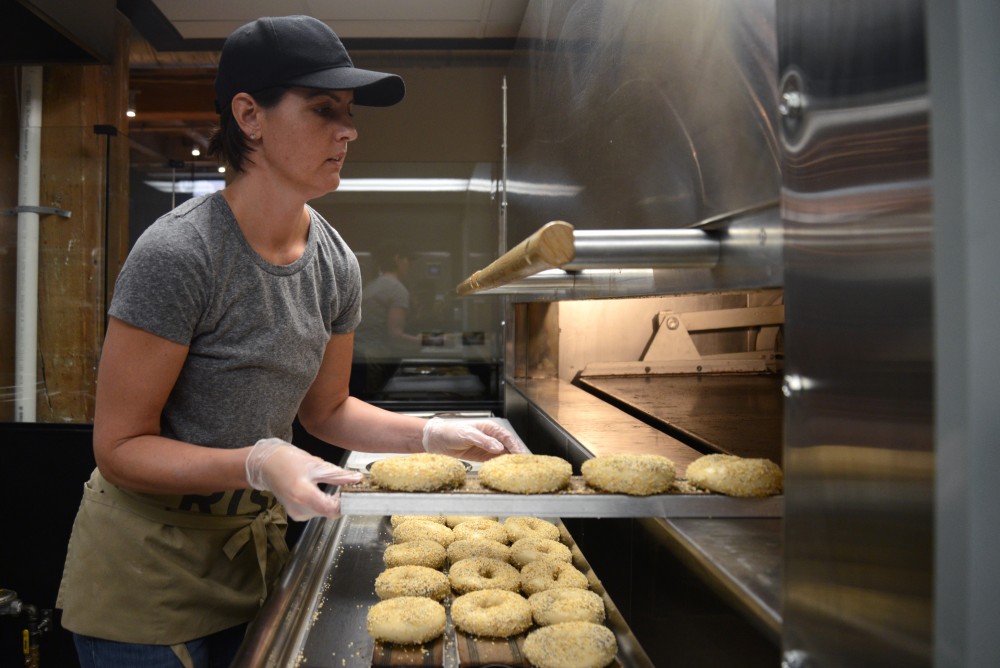 Jen Lloyd slides a rack of everything bagels in the oven at Rise Bagel Co. in Minneapolis on Tuesday. 