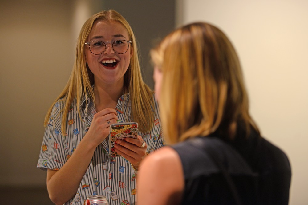 Ellie Peterson, social media editor at the Riveter laughs while talking to groups of Lit Crawl attendees