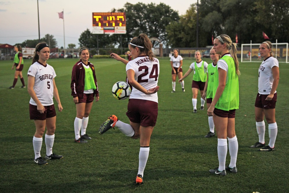 Sophomore defender Marisa Windingstad juggles the ball with her teammates at halftime on Thursday, Sept. 21.