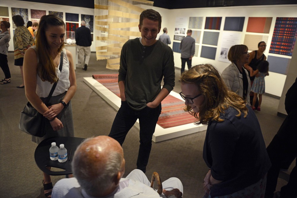 Jack Lenor Larsen talks with UMN interior design majors, Ave Paschke, left, Ryan Welters and Emily Walther, during the opening of an exhibit influenced by Larsens work on Friday, Sept. 22 at the Goldstein Museum of Design in St. Paul. 