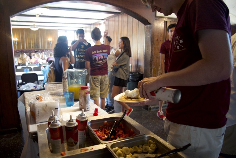 Donators help themselves to waffles inside Phi Sigma Kappa on Sunday, Sept. 24.