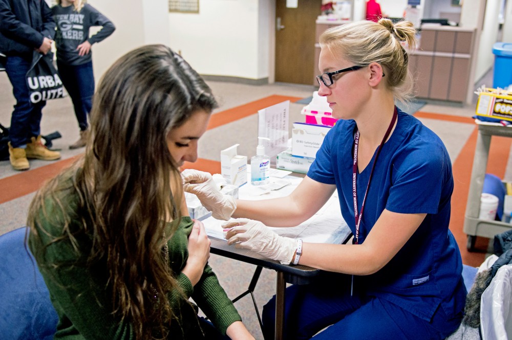Student Nicole Lyren gets a flu shot at a walk-in clinic at Boynton Health Dec. 8, 2015.