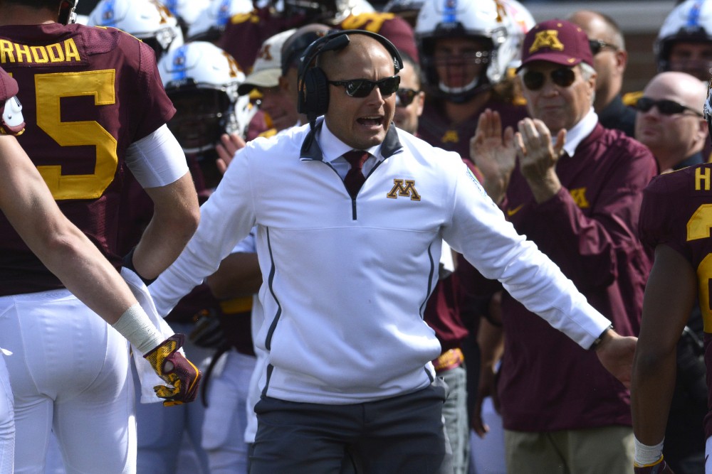 Head Coach P. J. Fleck congratulates players after a successful play on Saturday at TCF Bank Stadium.