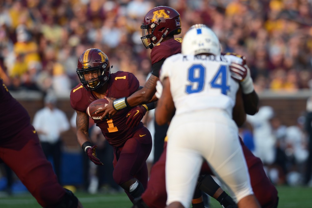 Quarterback Demry Croft hands the ball to running back Rodney Smith at TCF Bank Stadium on Thursday, August 31, 2017. The Gophers beat Buffalo 17 to 7.