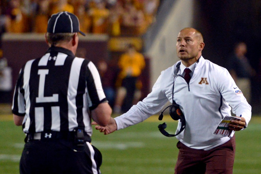 Head coach P.J. Fleck speaks to a referee at TCF Bank Stadium on Thursday, August 31, 2017.