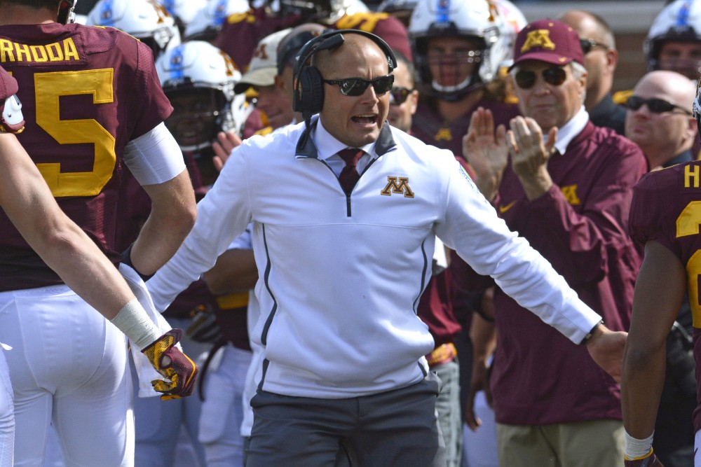 Head coach P. J. Fleck congratulates players after a successful play on Saturday, Sept. 30 at TCF Bank Stadium.