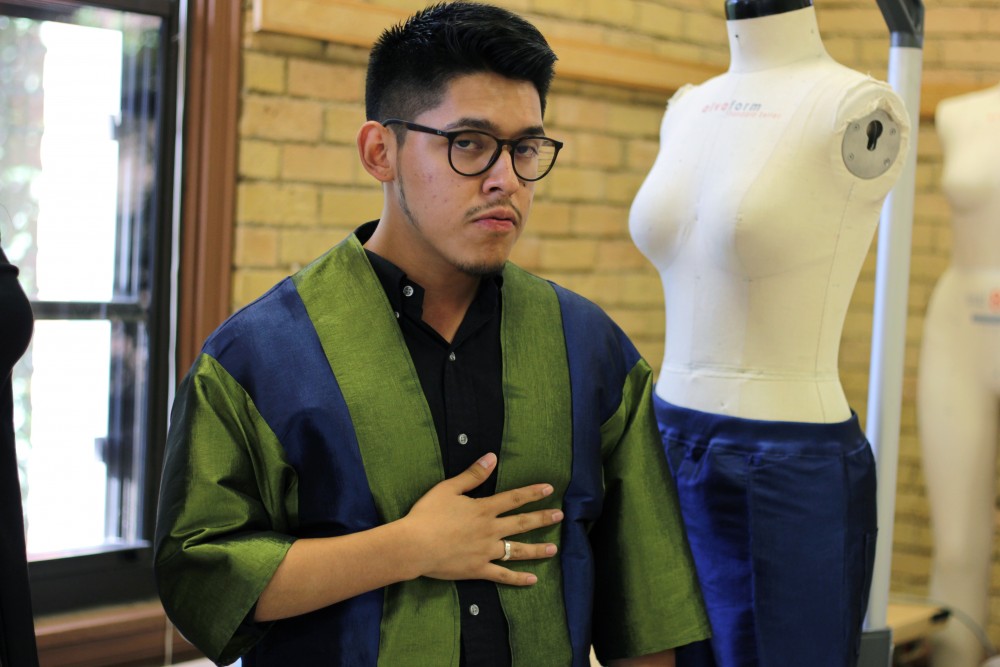 Fashion designer and apparel design major Ivan Gil showcases his unisex outfit that he designed in McNeal Hall on Friday, Sept. 29.