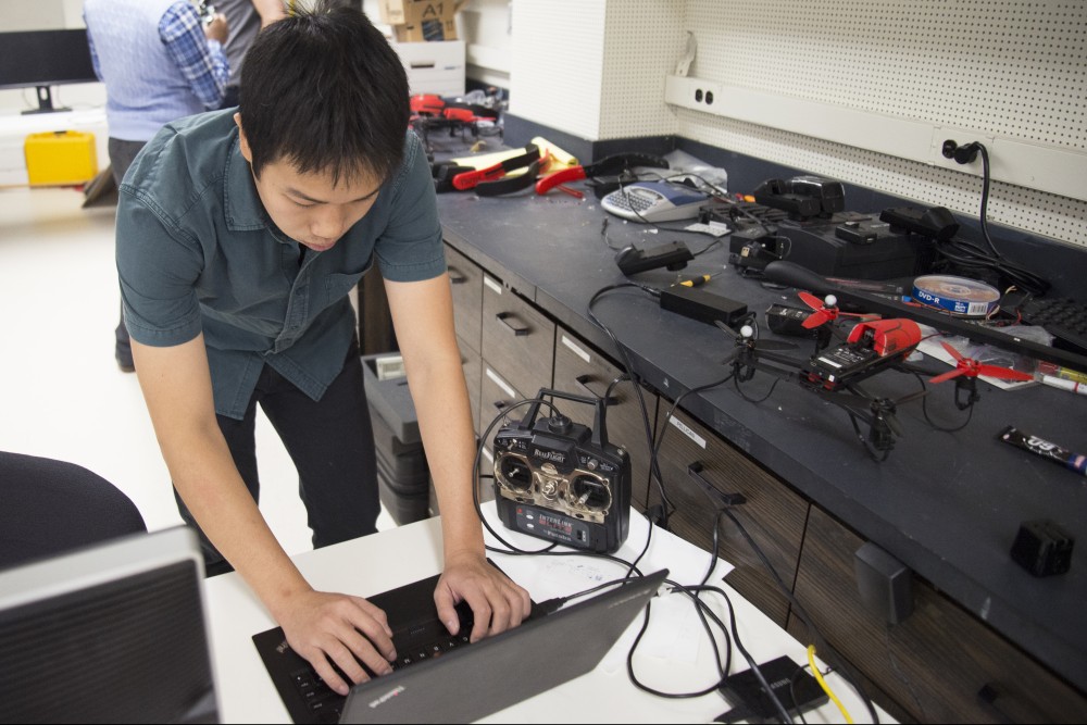 Grad student Tien Do inputs data into a computer to demonstrate a drone flying in the MARS lab on Friday, Sept. 29.  