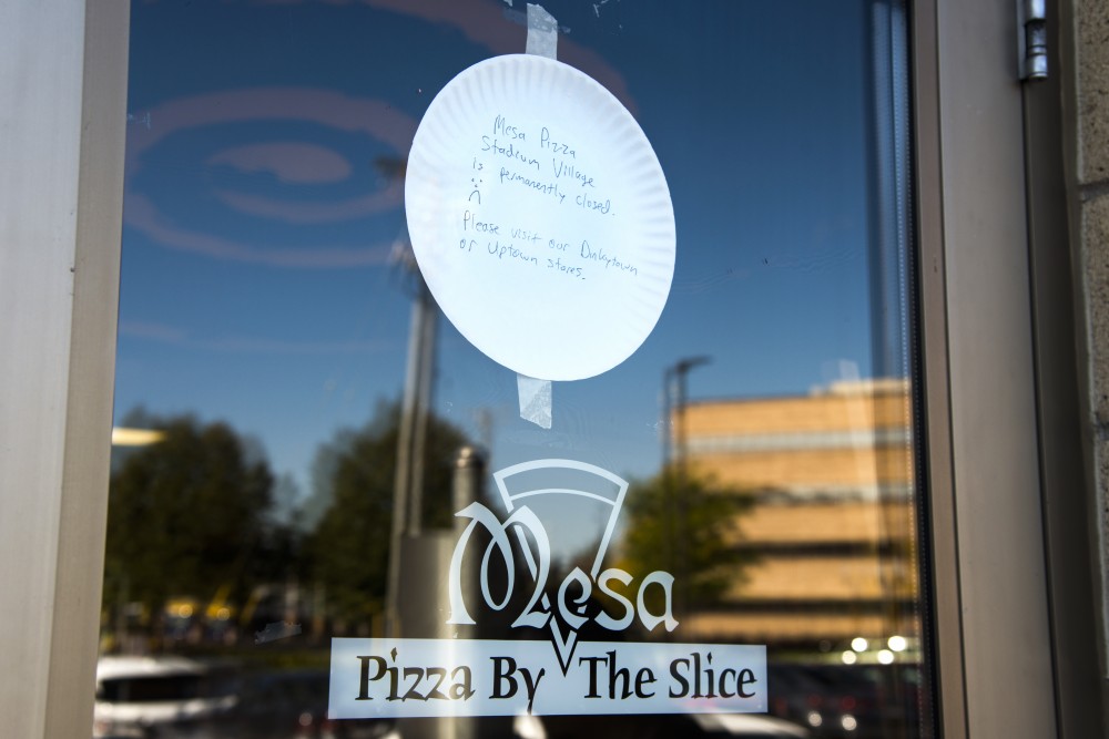 A paper plate reading Mesa Pizza Stadium Village is permanently closed hangs taped to the door of the Stadium Village Mesa Pizza location on Sunday. 