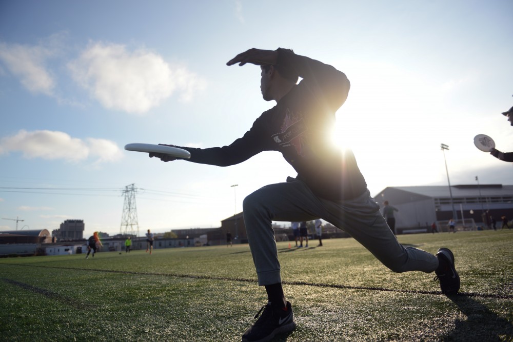 Captain Saurav Dubey throws a frisbee at teammates during practice on Wednesday, Oct. 11.