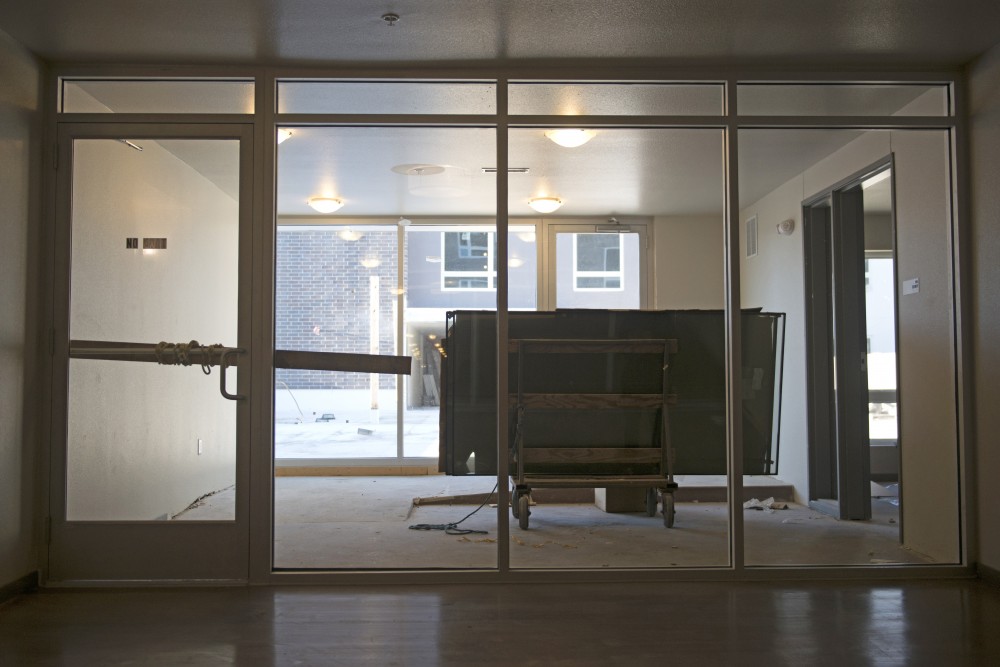 A wooden plank chained to the door serves as a locking mechanism to keep people from entering an unfinished rooftop terrace on Monday at the unfinished Prime Place Apartments.