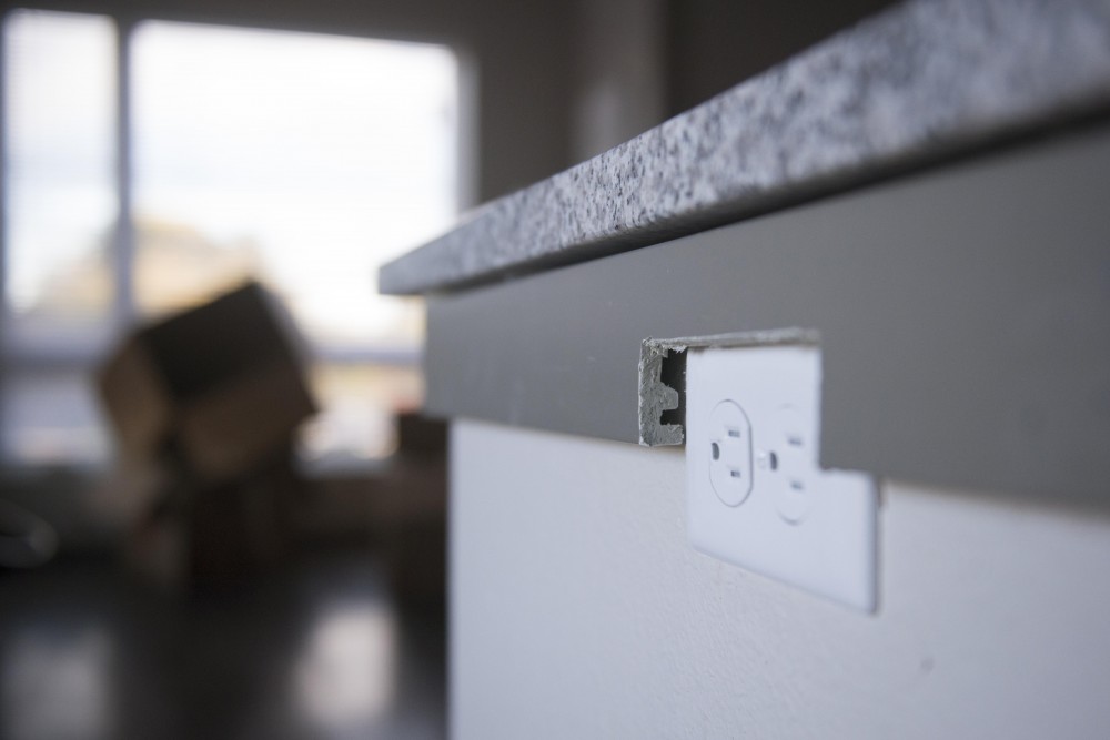 Poorly constructed countertop trim around a power outlet highlights some of the issues at the unfinished Prime Place Apartments Monday.