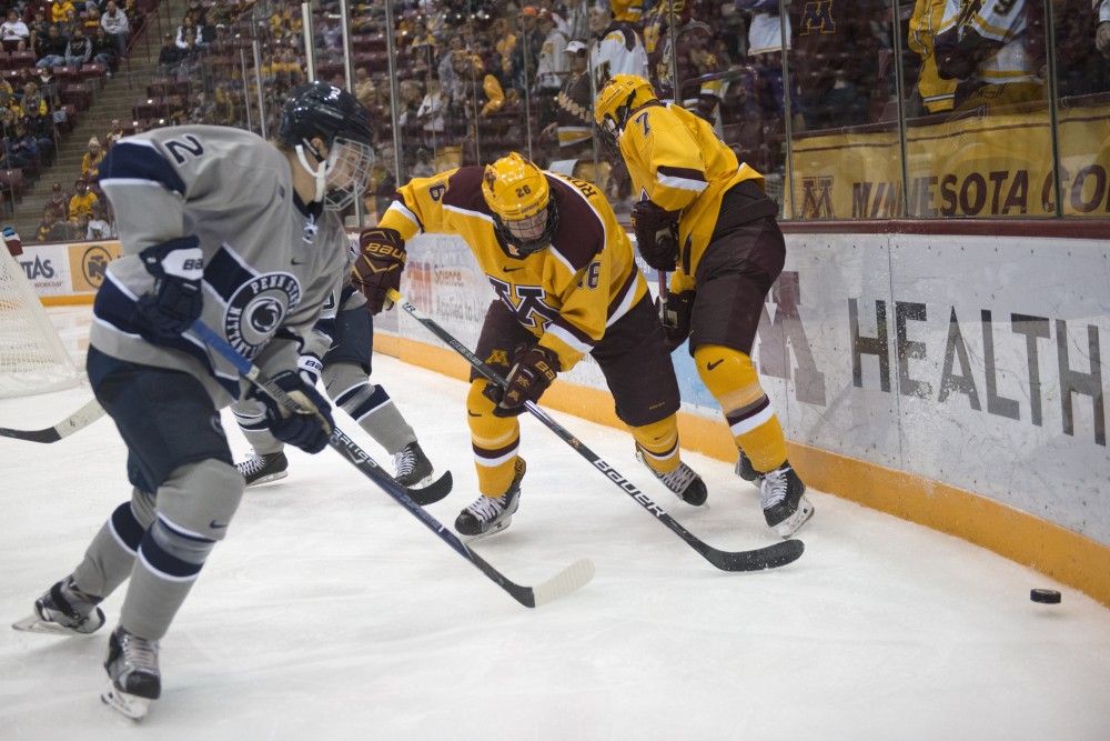 Forward Darian Romanko fights for the puck at 3M Arena at Mariucci on Saturday, Oct. 15.