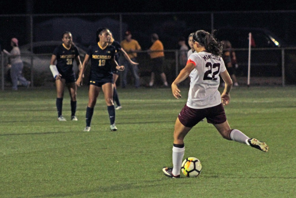 Tori Burnett passes the ball to a teammate in the game against the University of Michigan on Sept. 21.