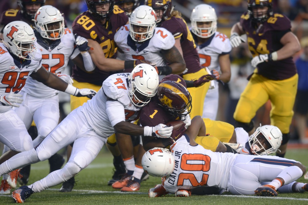 Rodney Smith is tackled at the homecoming game against Illinois at TCF Bank Stadium on Saturday, Oct. 21.