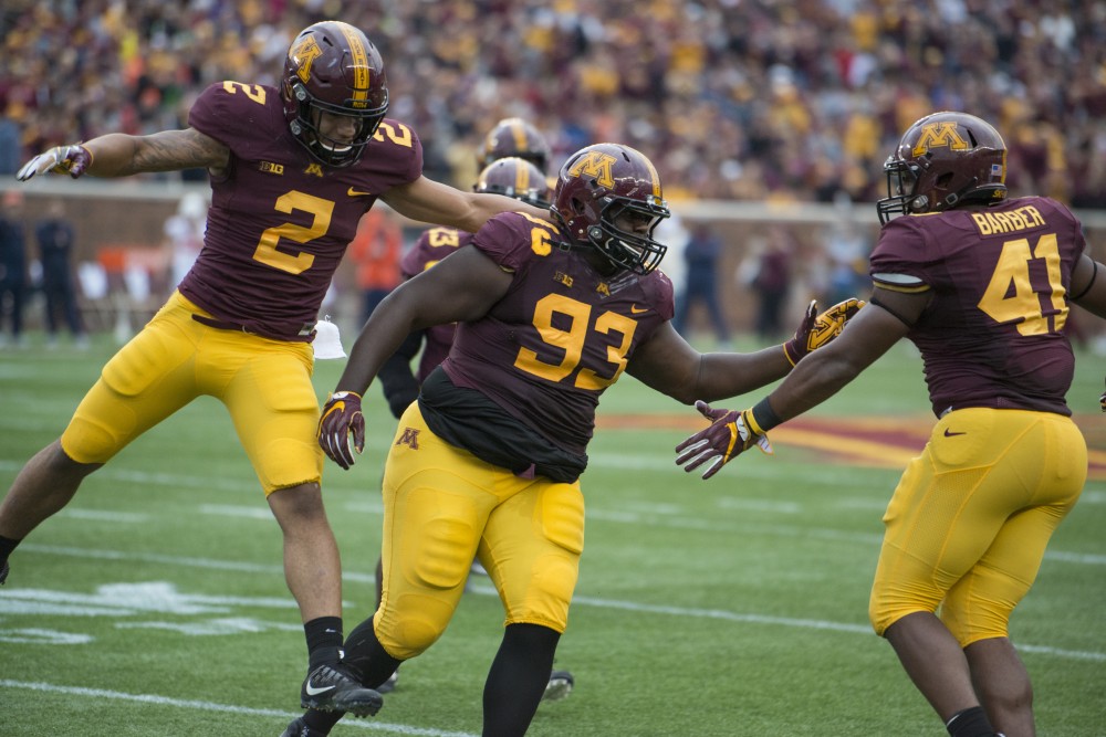 Merrick Jackson celebrates his forced fumble with Thomas Barber at the homecoming game against Illinois at TCF Bank Stadium on Saturday, Oct. 21.