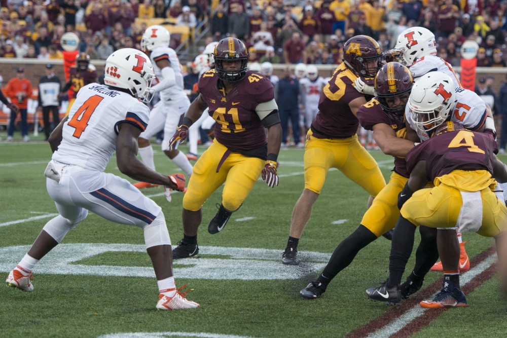 Defensive back Adekunle Ayinde tackles Illinois running back RaVon Bonner as he carries the ball on Saturday, Oct. 21 at TCF Bank Stadium. The Gophers defeated Illinois 24-17 during the homecoming game.